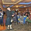 Bagpiper Jeff Edwards leads the DANG Cadet Squadron color guard into the hall for the posting of colors 